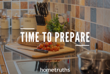 A kitchen view- tomatoes, bread, and a knife on top of a chopping board surrounded with other cooking materials