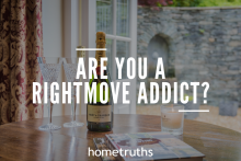 A bottle of wine, a scented candle, and books on top of a table