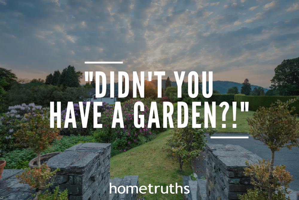 A garden outside a house with a lot of flowers and plants